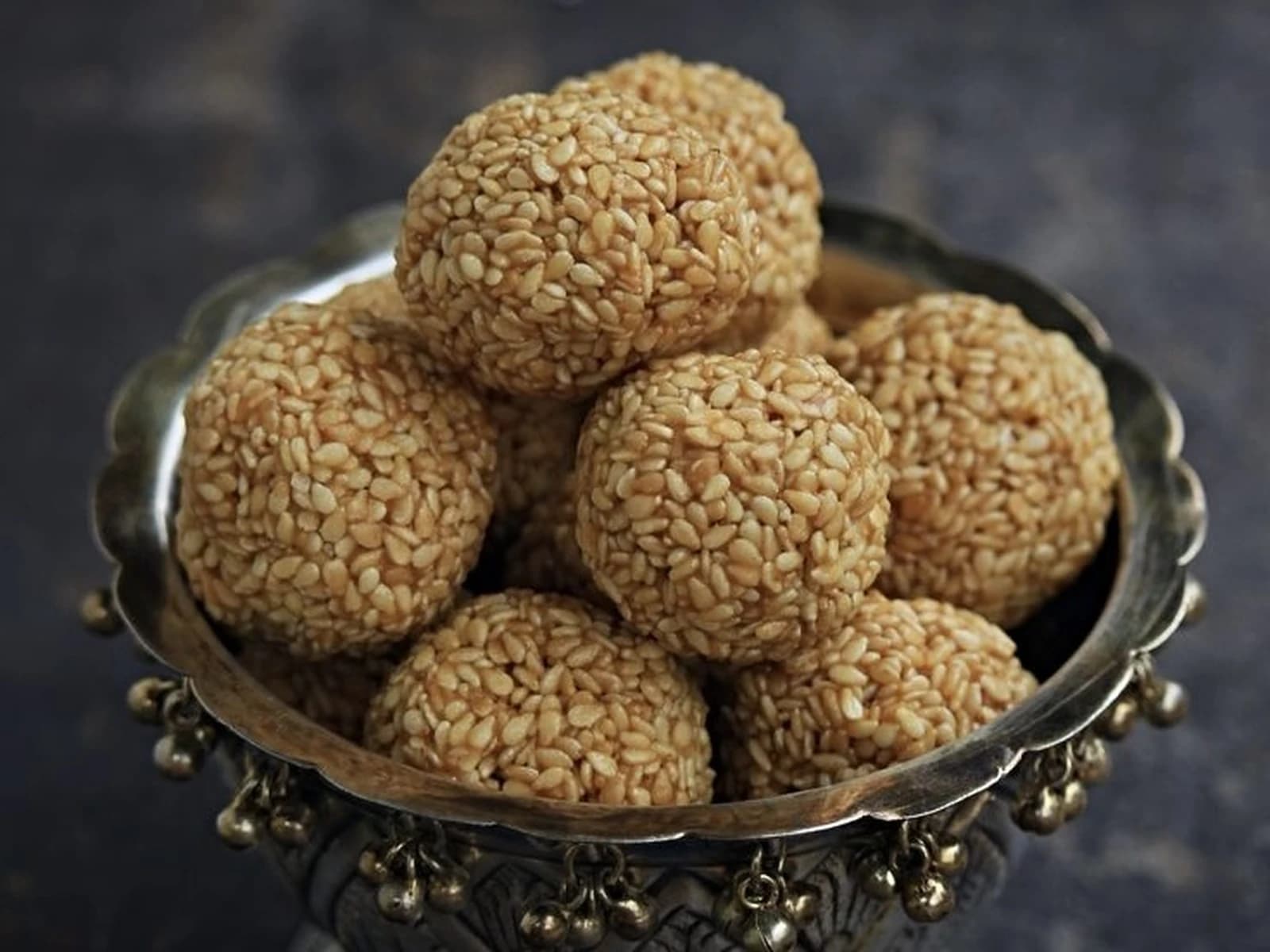 Bowl of bellam nuvvula undalu, round sesame seed balls