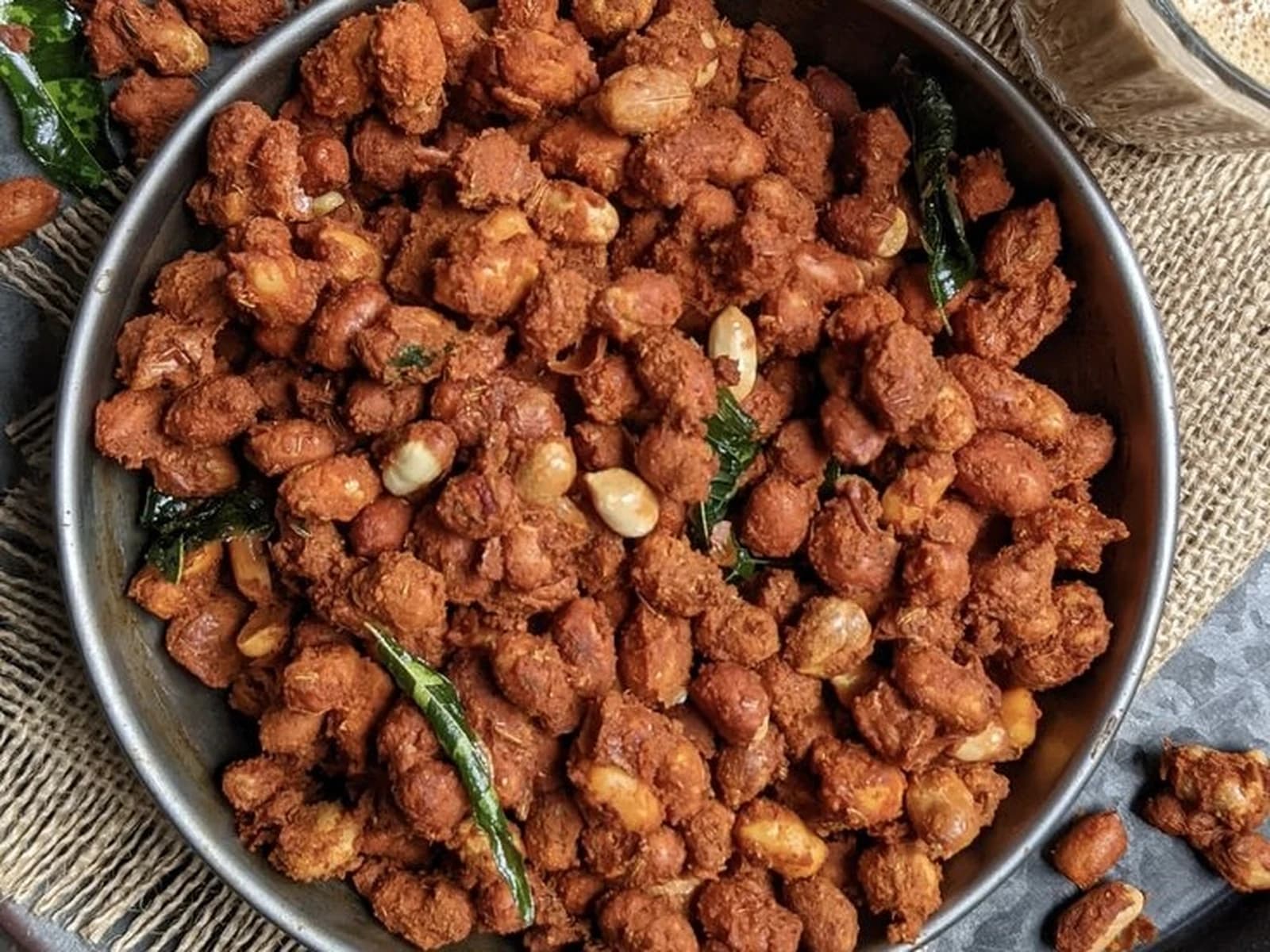 Pan of palli pakodi, peanuts fried in a spiced gram flour coating with curry leaves